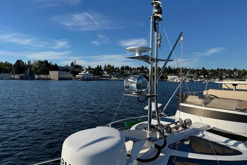 Buoy Boys Yacht Photos Pics 2025 Ranger Tugs R-29 CB boat on a serene lake with clear blue skies.