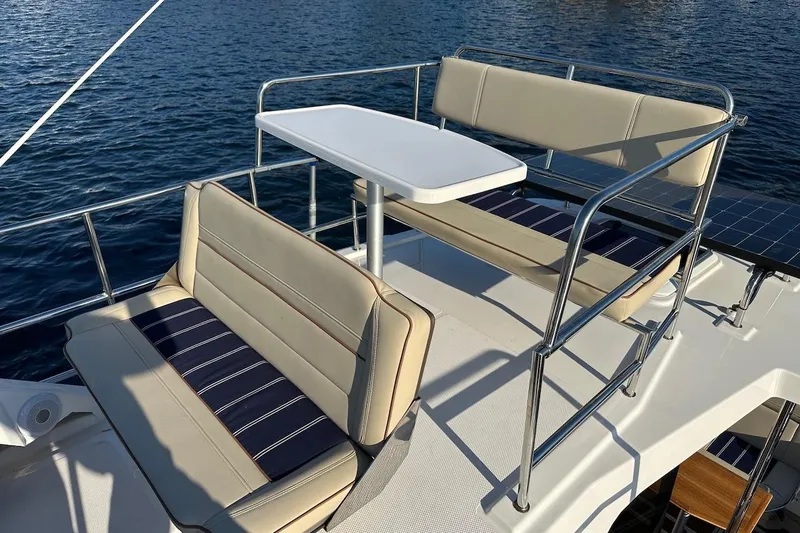 Buoy Boys Yacht Photos Pics 2025 Ranger Tugs R-29 CB boat deck with seating and table, overlooking water.