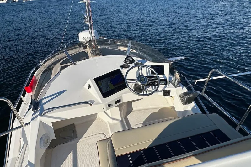 Buoy Boys Yacht Photos Pics 2025 Ranger Tugs R-29 CB helm with navigation screens on open water.