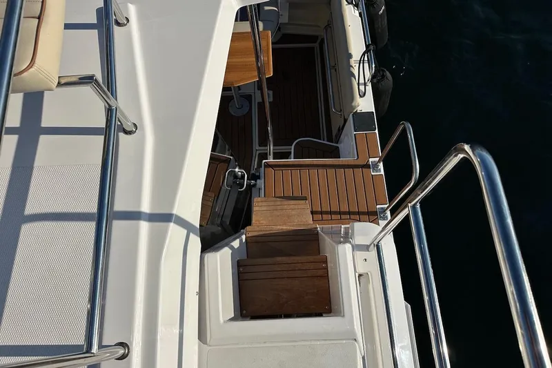 Buoy Boys Yacht Photos Pics 2025 Ranger Tugs R-29 CB boat deck with wooden flooring and metal railings.