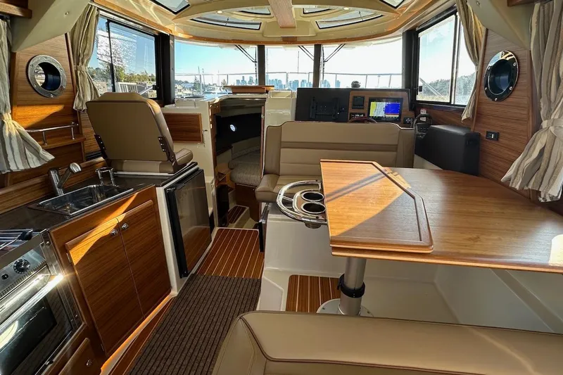 Buoy Boys Yacht Photos Pics Luxurious interior of 2025 Ranger Tugs R-29 CB with modern amenities and wood finishes.
