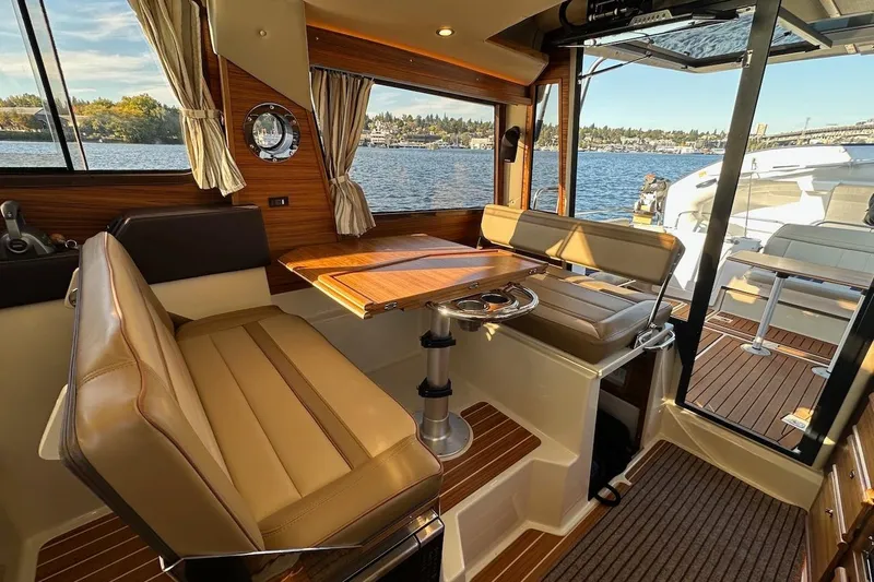 Buoy Boys Yacht Photos Pics 2025 Ranger Tugs R-29 CB interior with elegant seating and scenic water view.