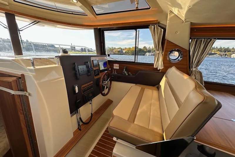 Buoy Boys Yacht Photos Pics Interior of 2025 Ranger Tugs R-29 CB boat with helm and seating area.