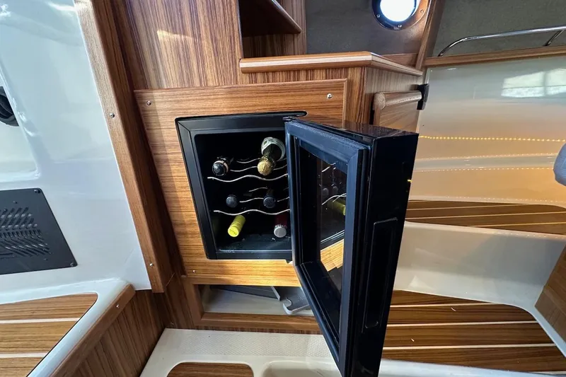 Buoy Boys Yacht Photos Pics 2025 Ranger Tugs R-29 CB interior with open wine cooler, showcasing elegant wood finish.