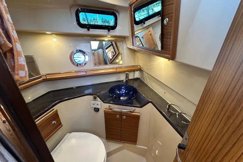 Buoy Boys Yacht Photos Pics Luxurious 2025 Ranger Tugs R-29 CB bathroom with modern fixtures and elegant wood accents.