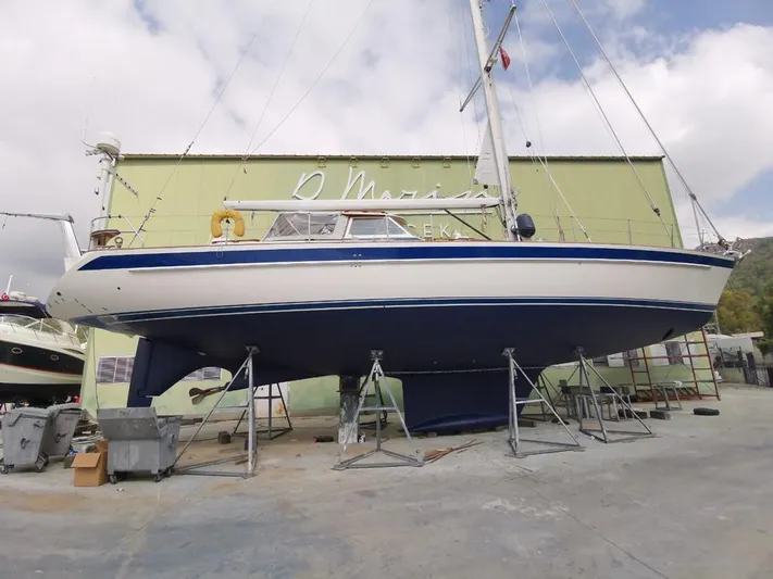  Yacht Photos Pics 2004 Hallberg-Rassy 62 sailboat on stands in a marina yard.