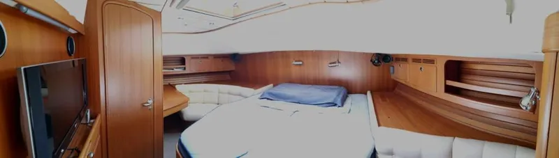  Yacht Photos Pics Luxurious cabin interior of a 2004 Hallberg-Rassy 62 yacht with wood paneling.