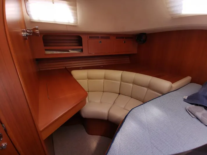  Yacht Photos Pics 2004 Hallberg-Rassy 62 yacht interior with cozy seating and wooden cabinetry.