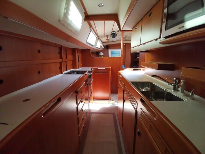  Yacht Photos Pics Interior of 2004 Hallberg-Rassy 62 yacht, featuring a spacious, well-equipped galley kitchen.