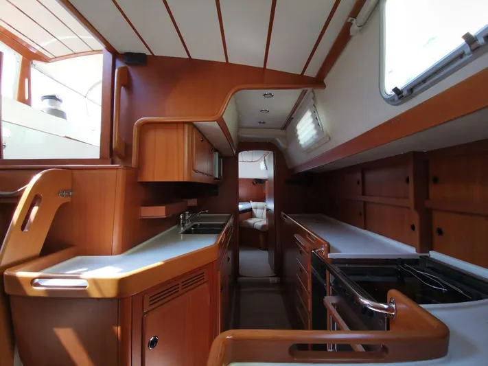  Yacht Photos Pics Interior of 2004 Hallberg-Rassy 62 yacht, featuring a sleek wooden galley and modern design.
