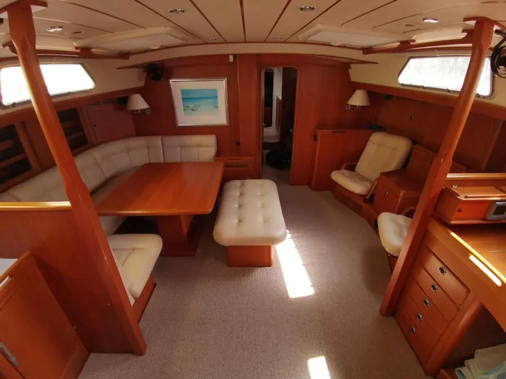  Yacht Photos Pics Luxurious 2004 Hallberg-Rassy 62 yacht interior with elegant wood and plush seating.