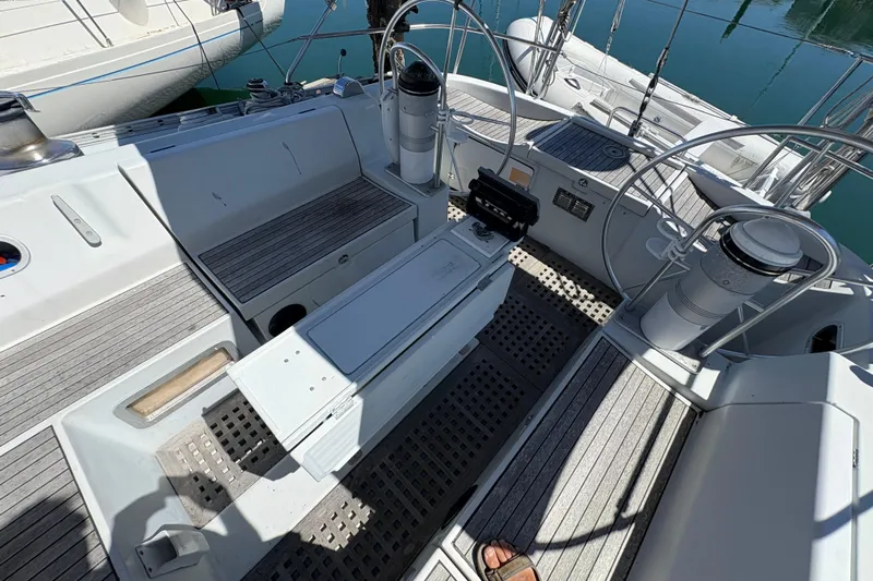 Skye Yacht Photos Pics Cockpit of 1990 Beneteau Oceanis 500 sailboat with dual steering wheels and seating.