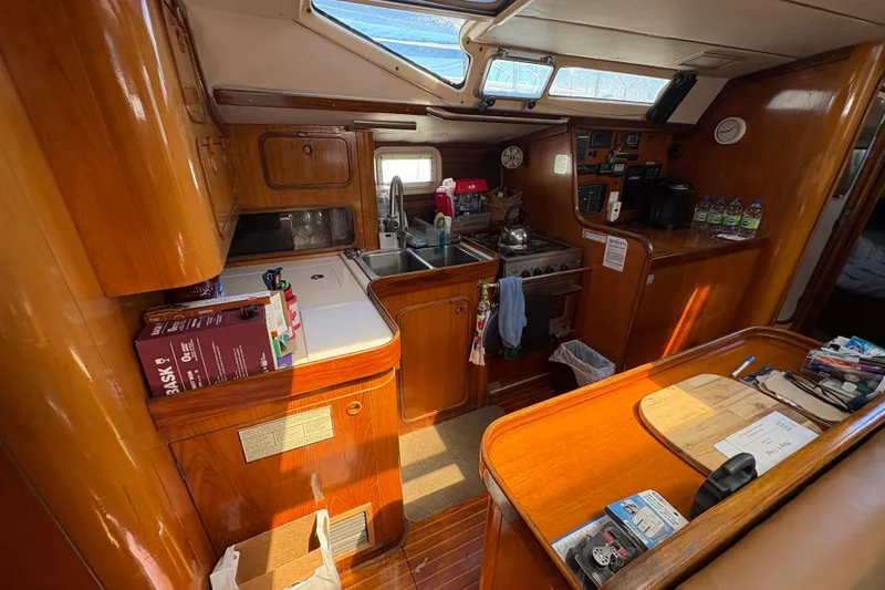 Skye Yacht Photos Pics Interior of 1990 Beneteau Oceanis 500 yacht with wooden cabinetry and kitchen amenities.