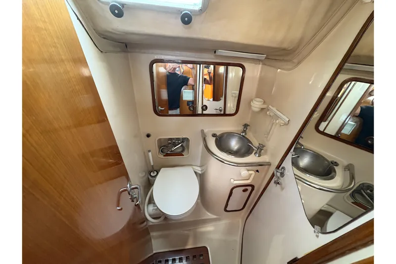 Skye Yacht Photos Pics Bathroom interior of 1990 Beneteau Oceanis 500 yacht, featuring sink and toilet.