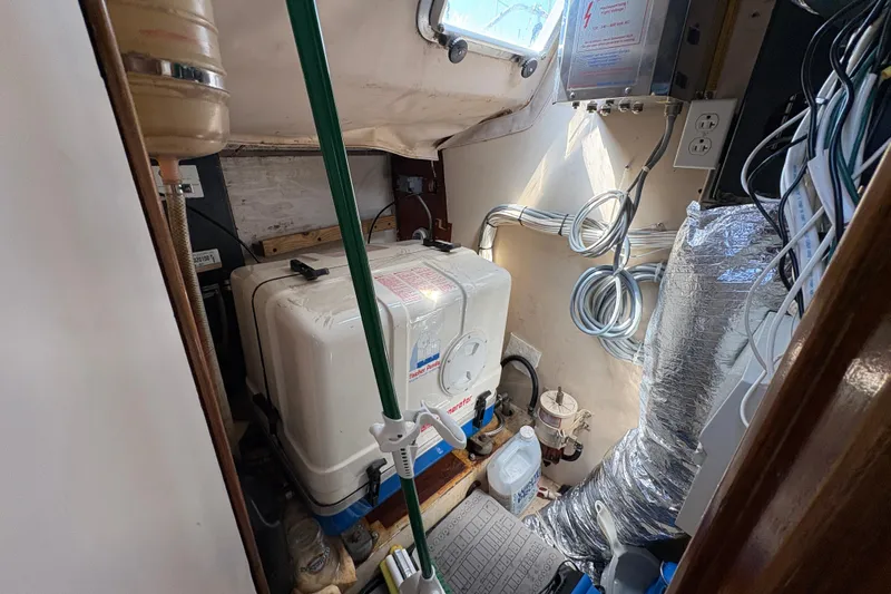 Skye Yacht Photos Pics Engine room of 1990 Beneteau Oceanis 500 sailboat, featuring generator and wiring.