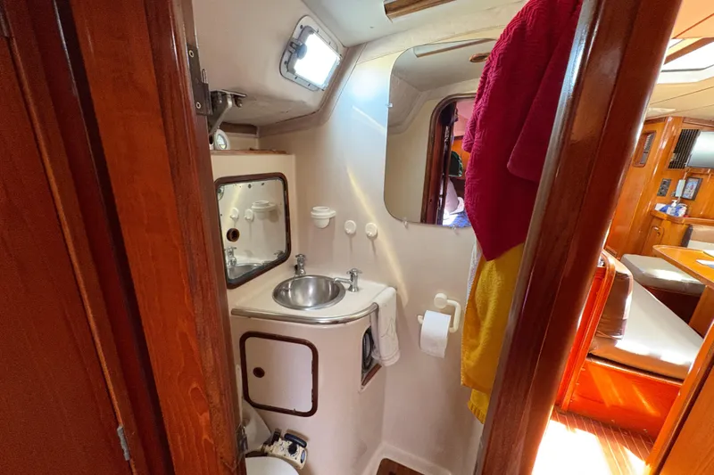 Skye Yacht Photos Pics Interior of 1990 Beneteau Oceanis 500 yacht bathroom with sink and mirror.