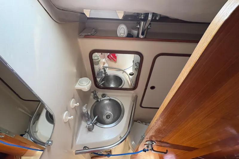 Skye Yacht Photos Pics Bathroom interior of 1990 Beneteau Oceanis 500 yacht with sink and mirror.