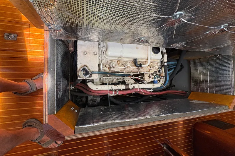 Skye Yacht Photos Pics Engine compartment of 1990 Beneteau Oceanis 500 sailboat with insulation and visible components.