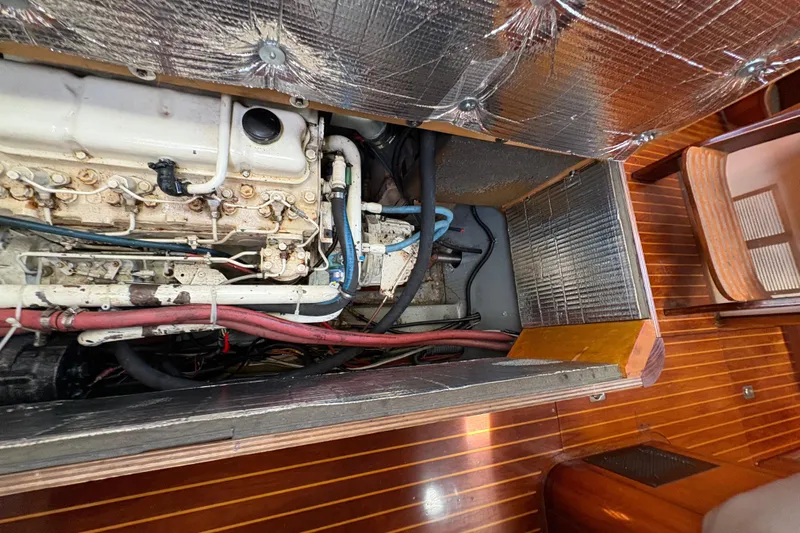 Skye Yacht Photos Pics Engine compartment of 1990 Beneteau Oceanis 500 sailboat, showcasing mechanical components and insulation.