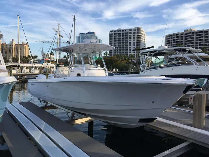 T/t Aloan At Last Yacht Photos Pics 2015 Edgewater 318CC boat docked at marina with city skyline in background.