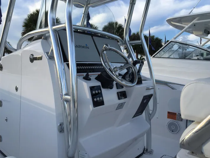 T/t Aloan At Last Yacht Photos Pics 2015 Edgewater 318CC boat console with steering wheel and Garmin display.