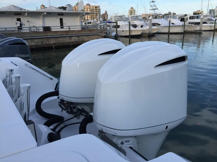 T/t Aloan At Last Yacht Photos Pics Twin Yamaha outboard engines on a 2015 Edgewater 318CC boat docked at a marina.
