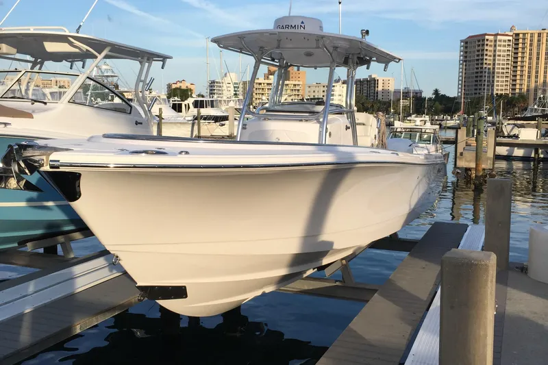 T/t Aloan At Last Yacht Photos Pics 2015 Edgewater 318CC boat docked at marina with cityscape background.