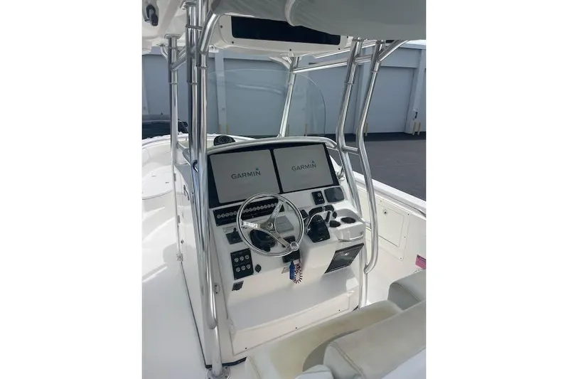 T/t Aloan At Last Yacht Photos Pics 2015 Edgewater 318CC boat console with Garmin navigation system and steering wheel.
