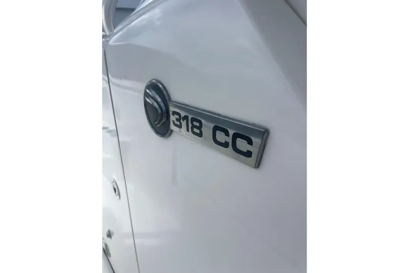 T/t Aloan At Last Yacht Photos Pics 2015 Edgewater 318CC boat emblem on white surface.