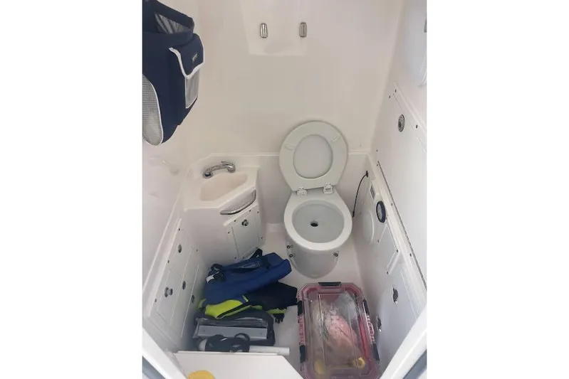 T/t Aloan At Last Yacht Photos Pics Interior of 2015 Edgewater 318CC boat with toilet and storage space.