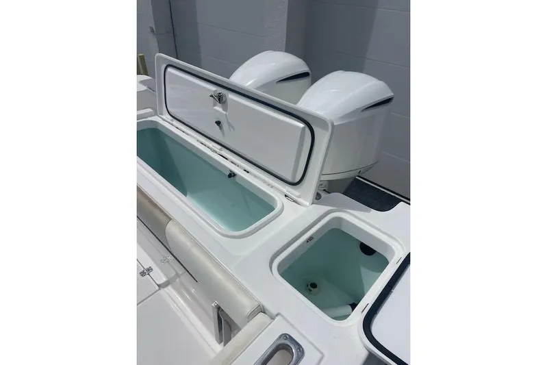 T/t Aloan At Last Yacht Photos Pics 2015 Edgewater 318CC boat with open storage compartments and dual engines.