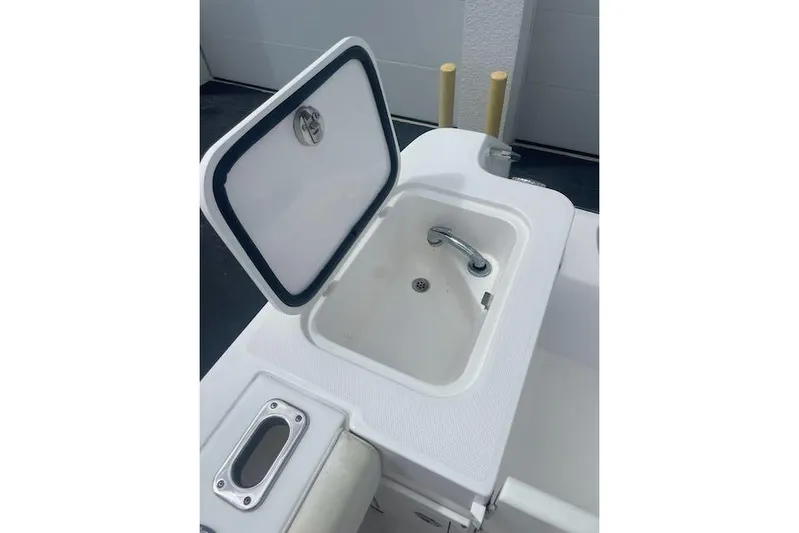T/t Aloan At Last Yacht Photos Pics 2015 Edgewater 318CC boat sink with open lid and faucet.
