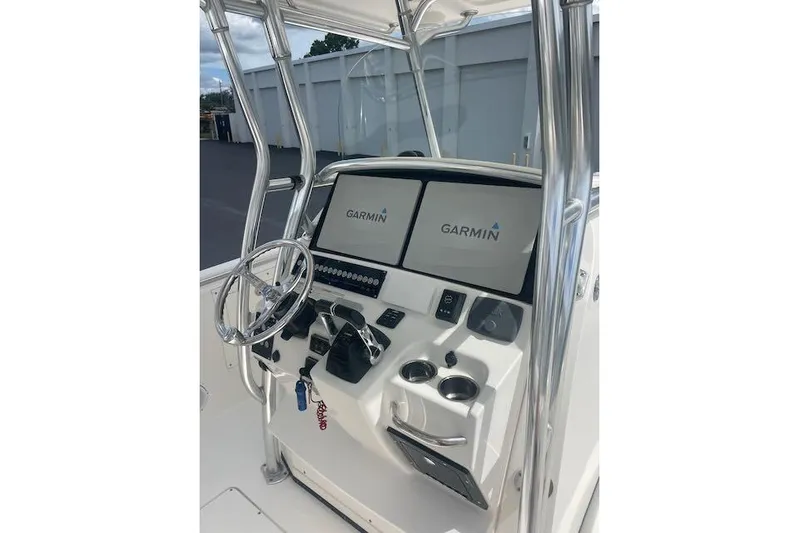 T/t Aloan At Last Yacht Photos Pics 2015 Edgewater 318CC boat console with Garmin navigation displays and steering wheel.