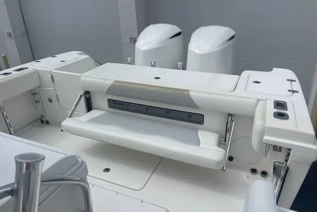 T/t Aloan At Last Yacht Photos Pics 2015 Edgewater 318CC boat interior with dual engines and seating area.