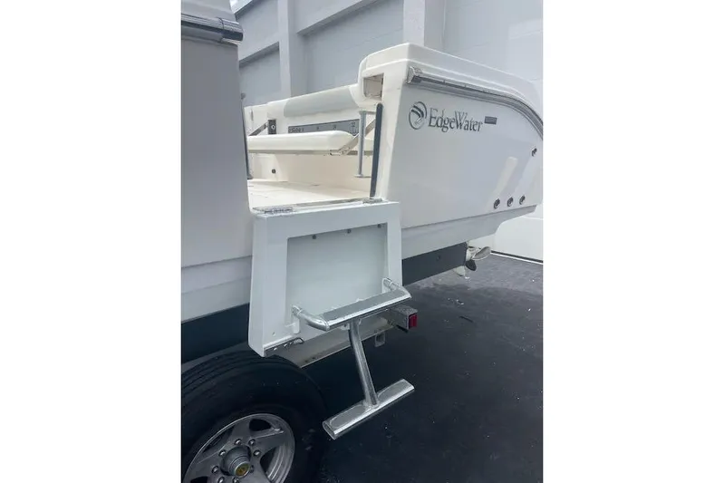 T/t Aloan At Last Yacht Photos Pics 2015 Edgewater 318CC boat rear view with ladder and logo.