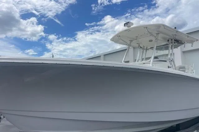 T/t Aloan At Last Yacht Photos Pics 2015 Edgewater 318CC boat under a partly cloudy sky.