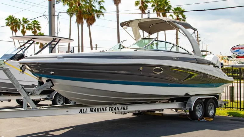  Yacht Photos Pics 2023 Crownline 290 XSS boat on a trailer at a marina.