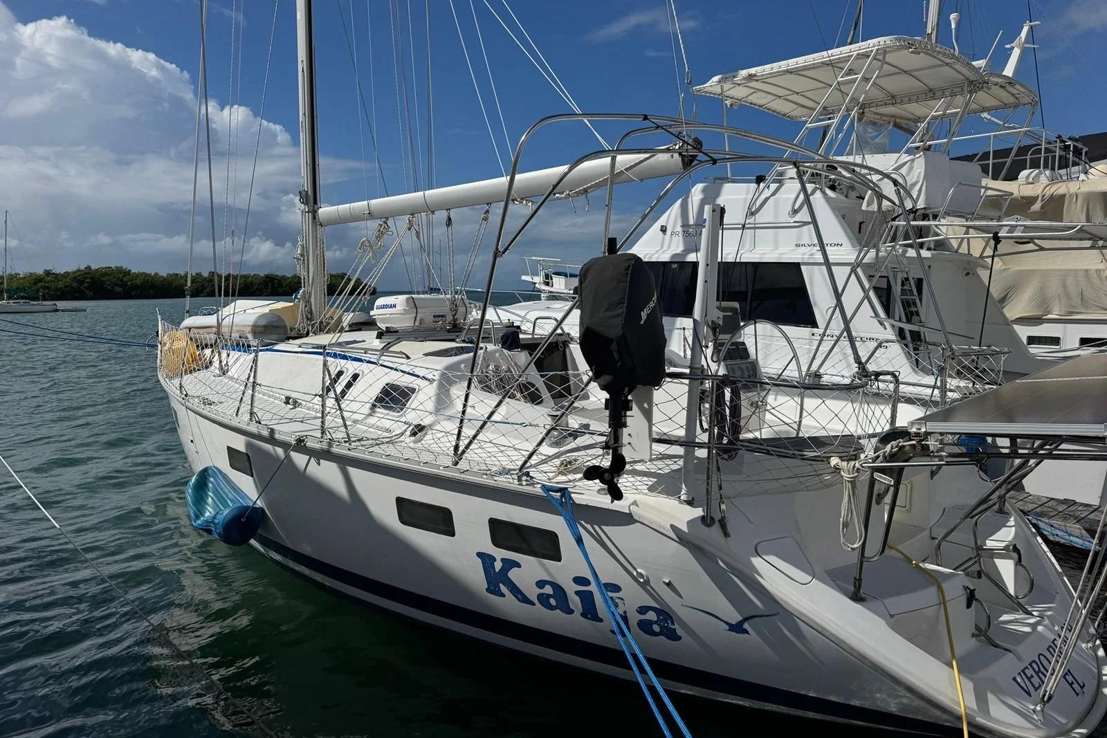 1994 Hunter Legend 40.5 sailboat docked in marina under clear blue sky.