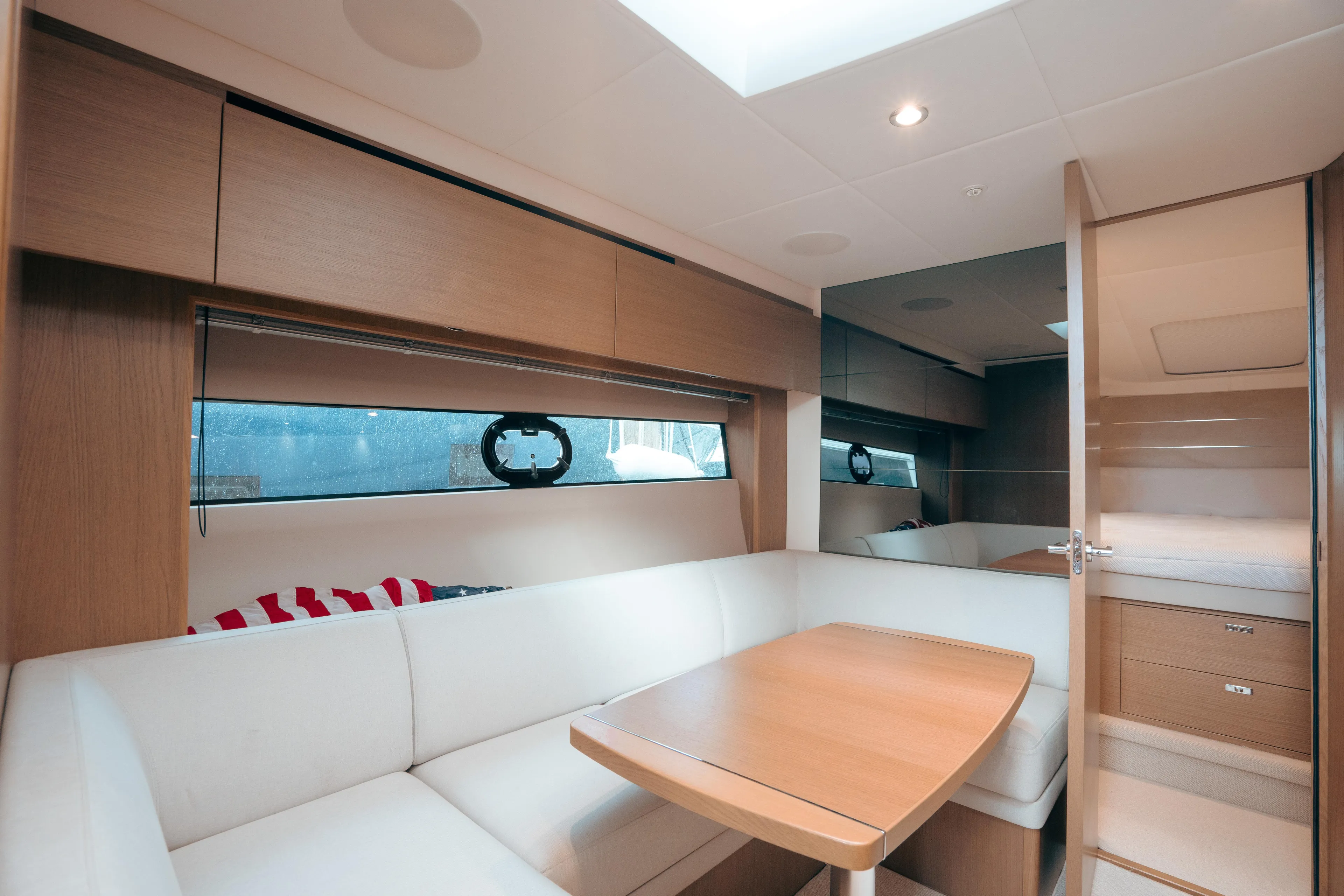 Angeliki Yacht Photos Pics Interior of 2021 Princess V40 yacht with modern seating and wooden table.