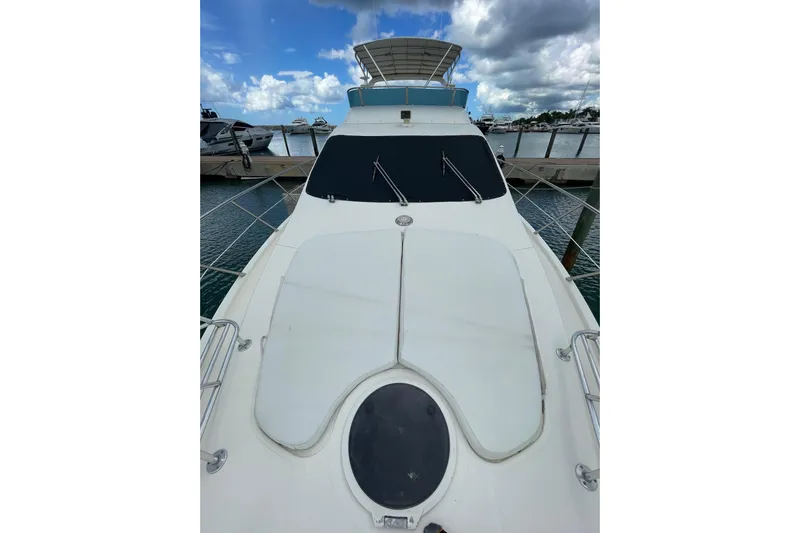  Yacht Photos Pics 2005 Azimut 55 Flybridge yacht docked, showcasing sleek design and spacious deck.