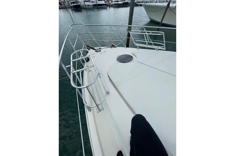  Yacht Photos Pics 2005 Azimut 55 Flybridge yacht deck with railing, docked in marina.