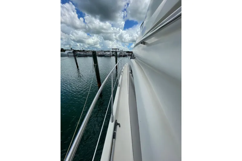  Yacht Photos Pics 2005 Azimut 55 Flybridge yacht docked, showcasing sleek design and marina view.