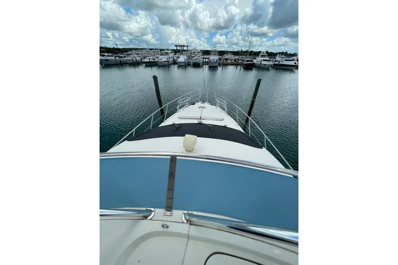  Yacht Photos Pics 2005 Azimut 55 Flybridge yacht docked at marina under cloudy sky.