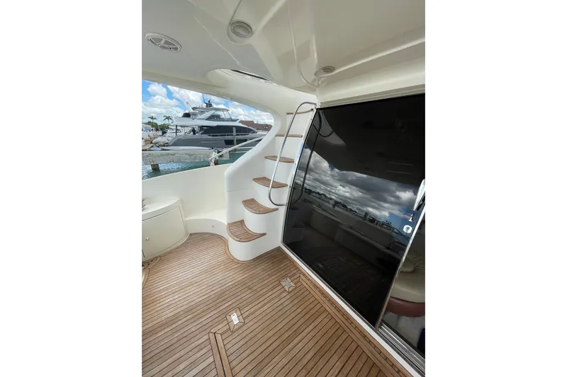  Yacht Photos Pics 2005 Azimut 55 Flybridge yacht with wooden deck and spiral staircase.