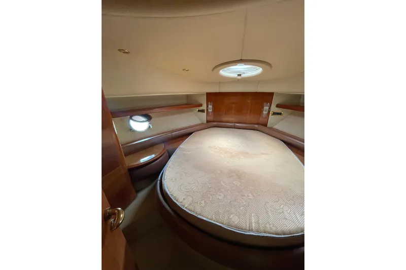  Yacht Photos Pics Luxurious bedroom interior of 2005 Azimut 55 Flybridge yacht with circular bed and porthole.