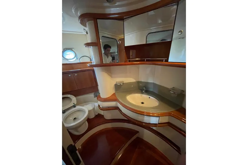  Yacht Photos Pics Luxurious bathroom in 2005 Azimut 55 Flybridge yacht with elegant wood finishes.
