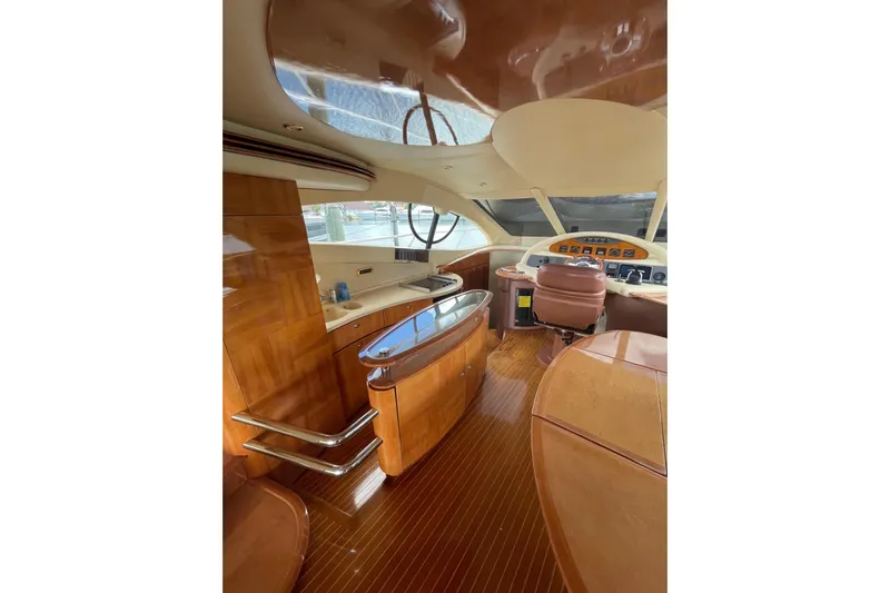 Yacht Photos Pics Luxurious interior of 2005 Azimut 55 Flybridge yacht with polished wood finishes.