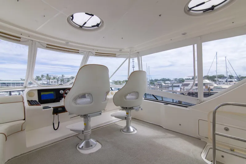 Immersed Yacht Photos Pics Interior view of 2009 Silverton Oviation 52 yacht helm with two captain chairs.