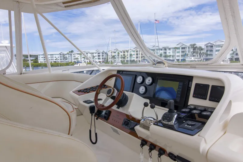 Immersed Yacht Photos Pics Helm of 2009 Silverton Oviation 52 yacht with modern navigation instruments and luxurious seating.