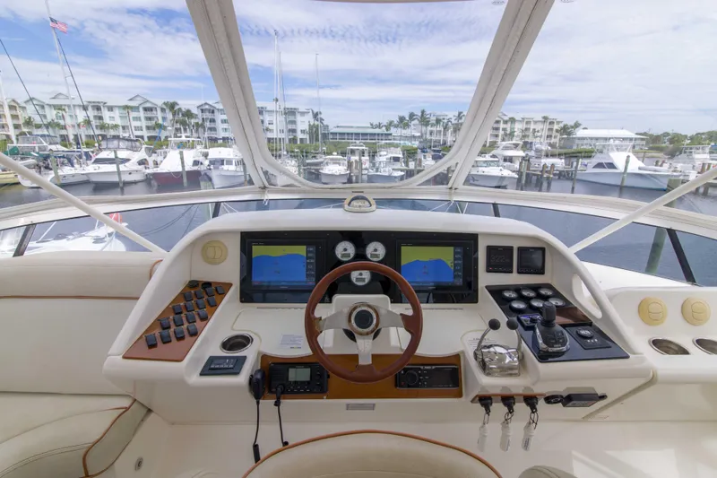 Immersed Yacht Photos Pics Helm of 2009 Silverton Oviation 52 yacht with navigation screens and controls, docked at marina.